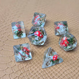 Clear resin D&D dice with red mushroom and moss encased inside, golden numbers, set on a textured leather background.