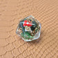Clear resin D20 with red mushroom and moss encased inside, golden numbers, set on a textured leather background.